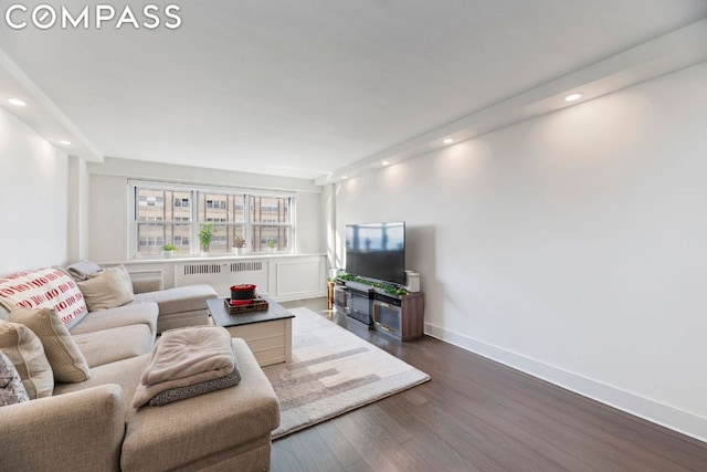 living room featuring radiator and dark hardwood / wood-style floors