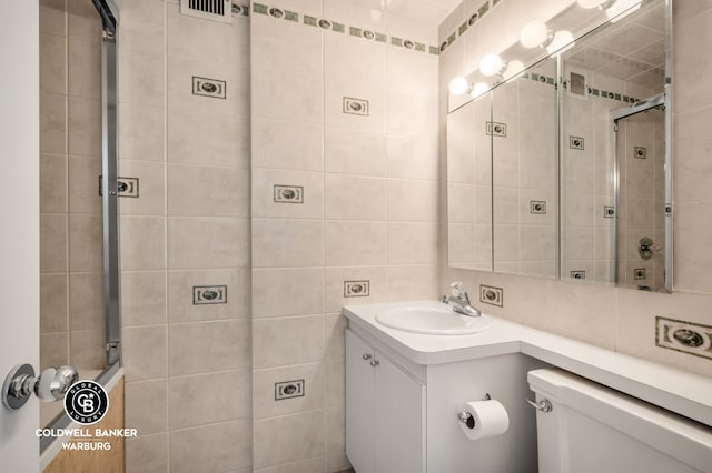 118 E 60th St Unit 28G, New York City, NY 10022 - full bath with a shower stall, vanity, and tile walls