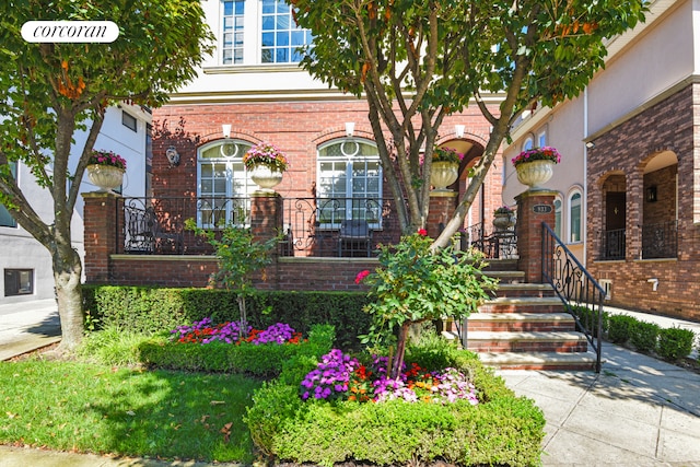 view of front of house with a porch and brick siding