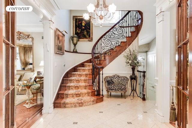 staircase featuring crown molding, tile patterned flooring, and decorative columns