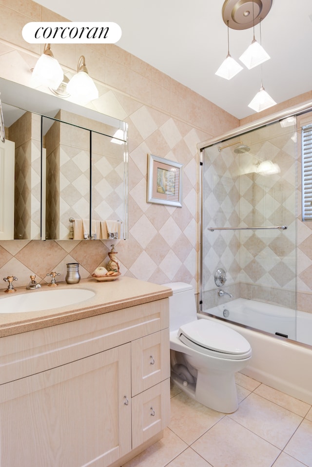 bathroom featuring vanity, backsplash, tile walls, and tile patterned floors