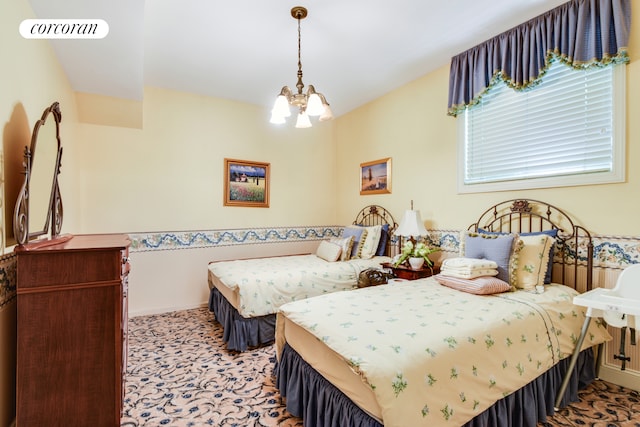 carpeted bedroom featuring baseboards, visible vents, and an inviting chandelier