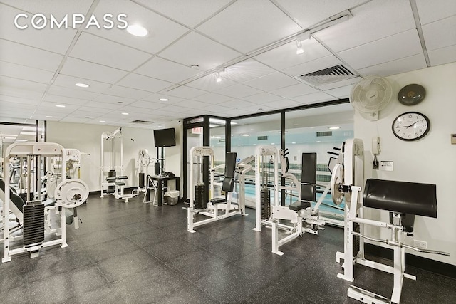 304 E 65th St Unit 38Ad, New York City, NY 10065 - exercise room with expansive windows and a paneled ceiling