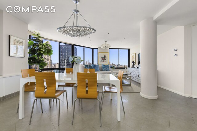 304 E 65th St Unit 38Ad, New York City, NY 10065 - dining space featuring floor to ceiling windows, baseboards, and a chandelier