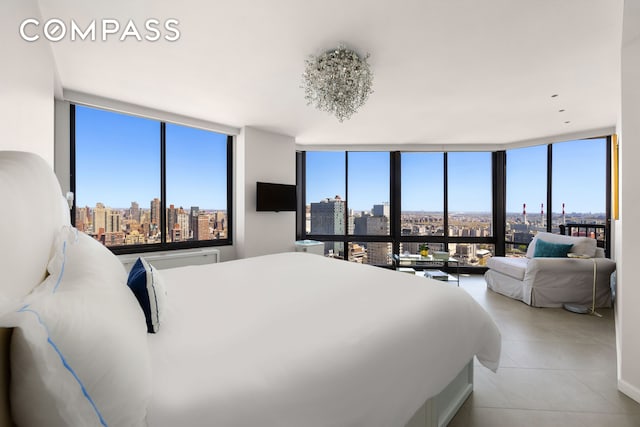 bedroom featuring a wall of windows, multiple windows, and light tile patterned flooring