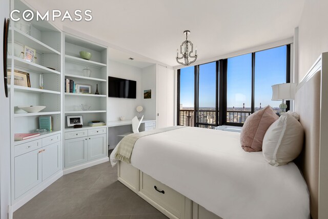 304 E 65th St Unit 38Ad, New York City, NY 10065 - bedroom featuring dark tile patterned floors, a chandelier, multiple windows, and access to outside