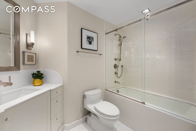 full bathroom featuring toilet, shower / bath combination with glass door, and vanity