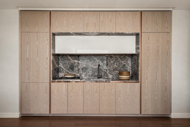 125 Greenwich St Unit 38B, New York City, NY 10006 - detailed view of baseboards, wood finished floors, a sink, and tasteful backsplash