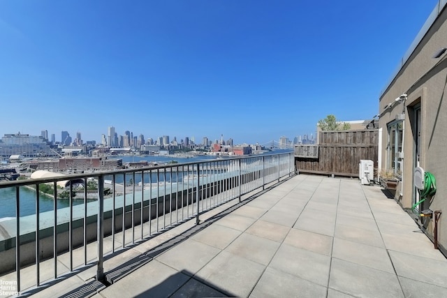 view of patio with a balcony and a city view