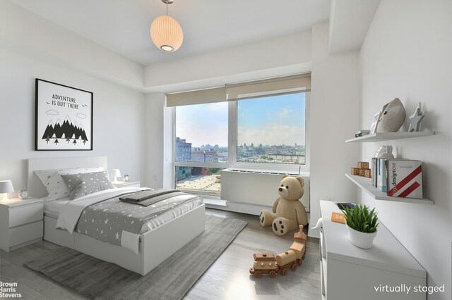 446 Kent Ave Phd, Phd, New York City, NY 11211 - bedroom with wood finished floors and a city view