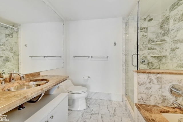 bathroom featuring a shower with shower door, vanity, and toilet