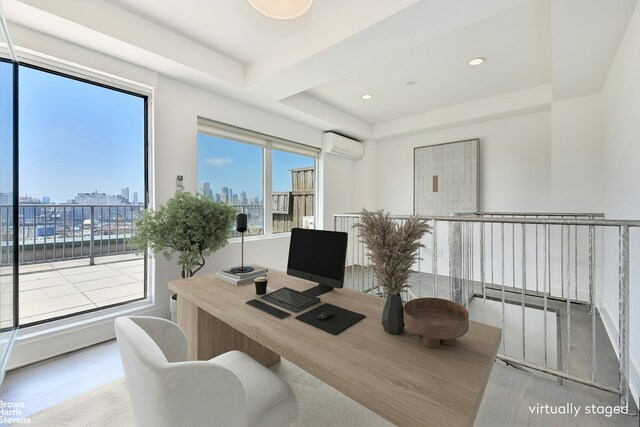 446 Kent Ave Phd, Phd, New York City, NY 11211 - home office featuring a wall mounted AC, a tray ceiling, wood finished floors, and recessed lighting