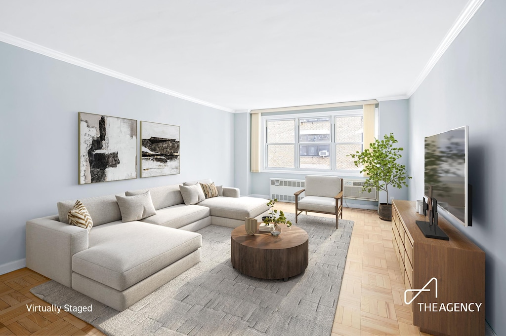 living room featuring baseboards, radiator, and crown molding