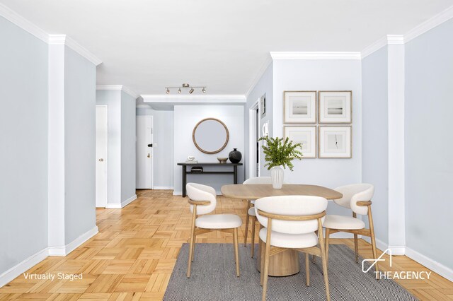 dining area featuring light parquet floors and ornamental molding