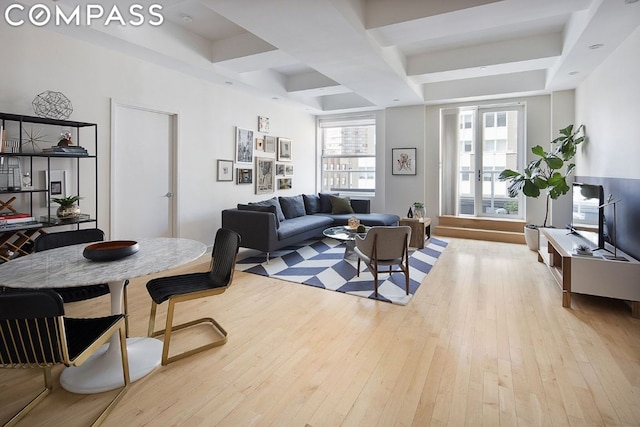 living room featuring beam ceiling, coffered ceiling, and light hardwood / wood-style floors