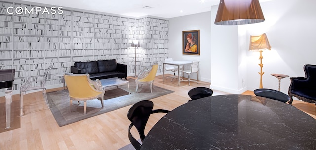 living area with baseboards and wood finished floors