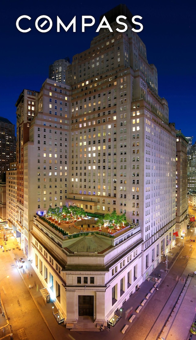 property at night featuring a view of city lights