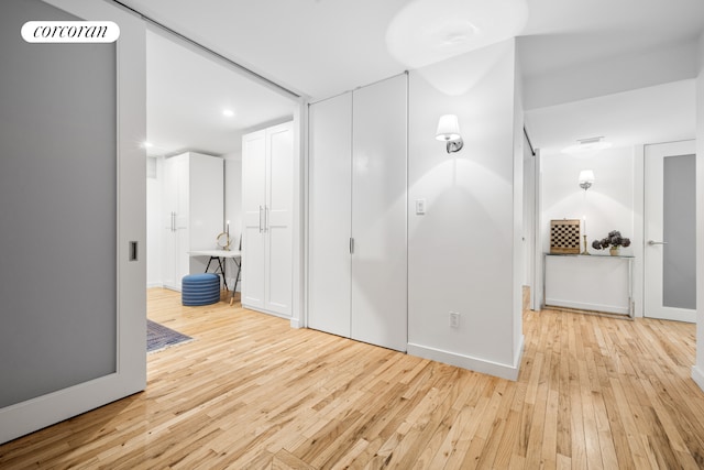 unfurnished bedroom featuring baseboards, visible vents, and light wood finished floors