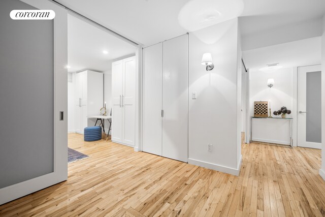 176 Broadway Unit 3C, New York City, NY 10038 - hallway featuring light wood-style floors, recessed lighting, and baseboards