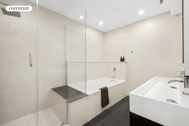 176 Broadway Unit 3C, New York City, NY 10038 - full bathroom with vanity, a shower stall, tile patterned flooring, tile walls, and tiled tub