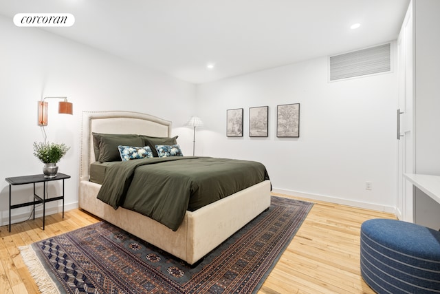 bedroom with recessed lighting, wood-type flooring, visible vents, and baseboards