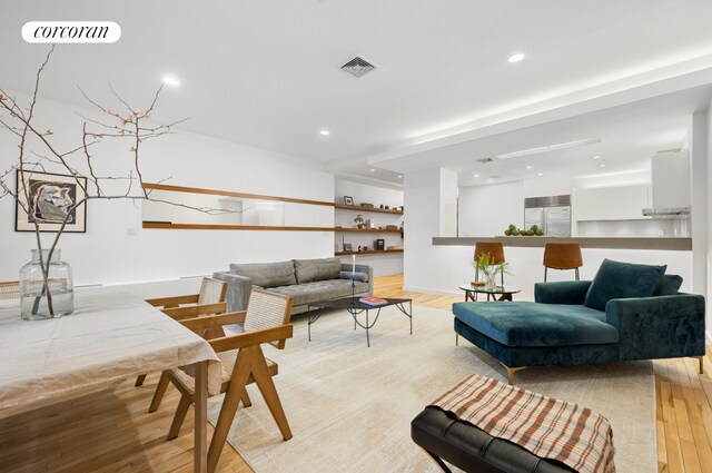 176 Broadway Unit 3C, New York City, NY 10038 - living area with light wood-style flooring, recessed lighting, and baseboards