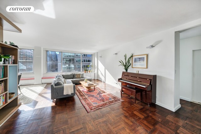 living room featuring dark parquet floors