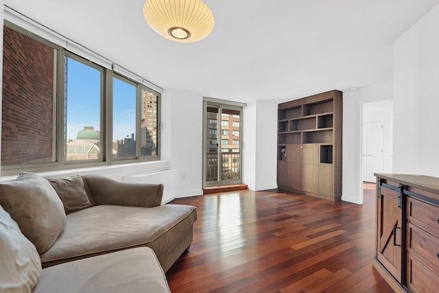 living room with baseboards and dark wood-style flooring