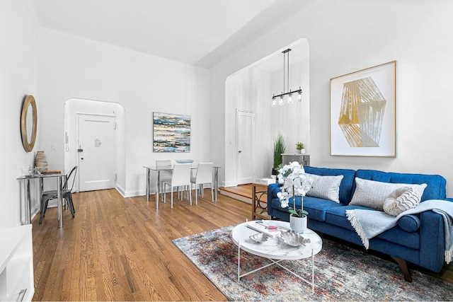 living room with a notable chandelier and hardwood / wood-style floors