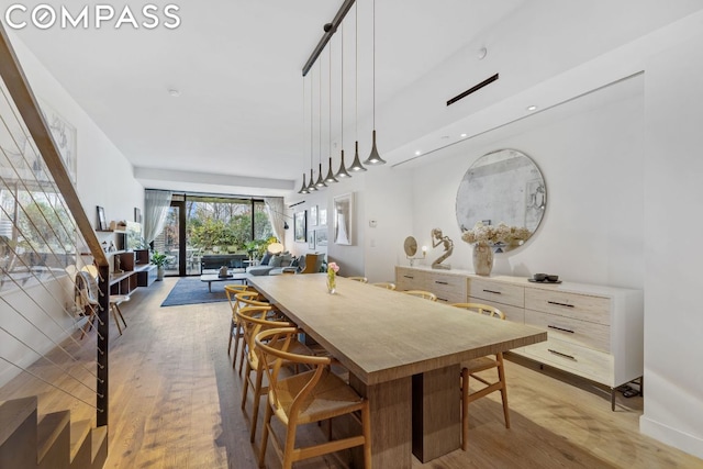 dining space with hardwood / wood-style floors