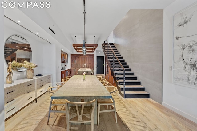 dining room with sink and light hardwood / wood-style floors