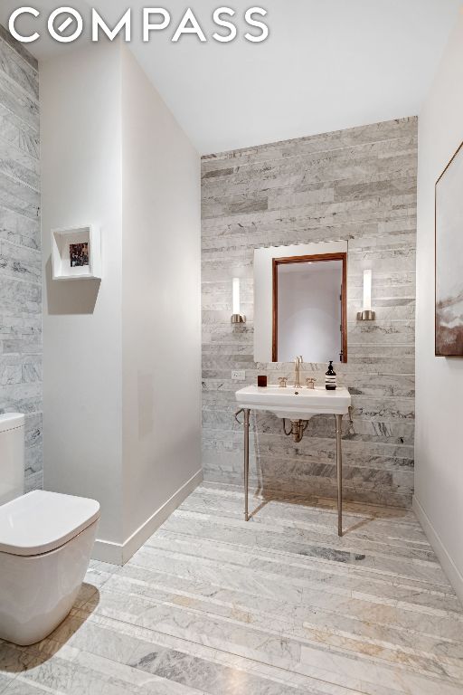 bathroom with toilet, hardwood / wood-style flooring, and sink