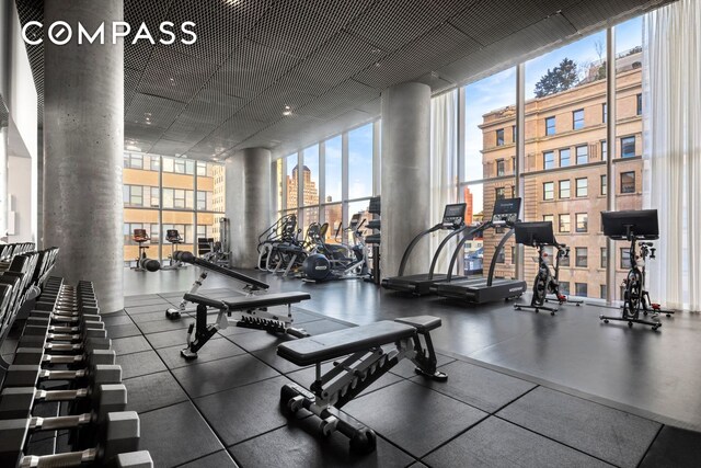 gym featuring a wall of windows and a wealth of natural light