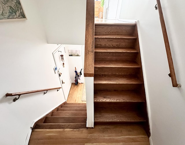 stairs featuring wood finished floors