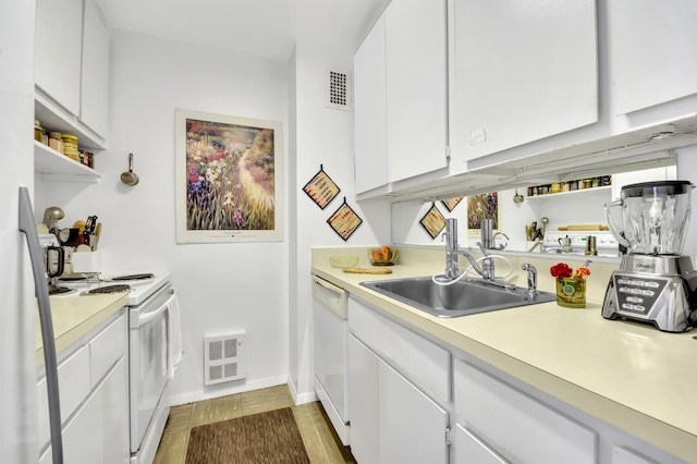 kitchen featuring visible vents, open shelves, white appliances, light countertops, and a sink
