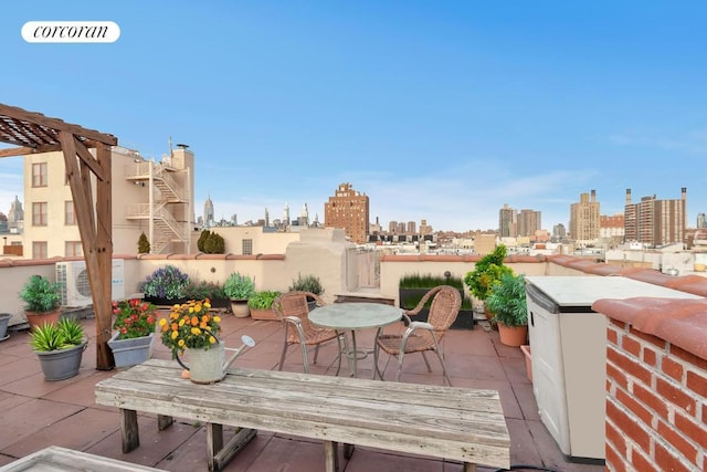 view of patio / terrace featuring a view of city, outdoor dining area, and stairs