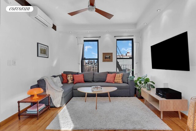 living room featuring light wood-style flooring, recessed lighting, a ceiling fan, and a wall mounted air conditioner