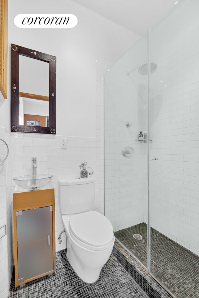 613 E 6th St Unit 5C, New York City, NY 10009 - full bath with vanity, a shower stall, tile patterned floors, and tile walls