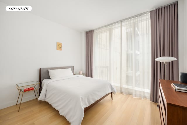 bedroom featuring visible vents and light wood finished floors