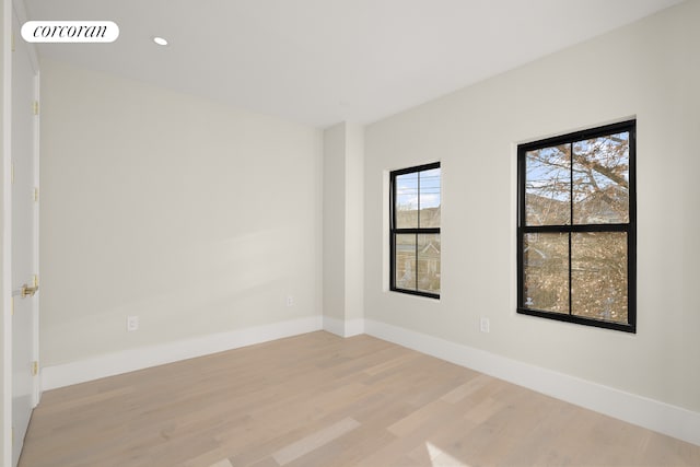 spare room featuring recessed lighting, light wood-style floors, visible vents, and baseboards