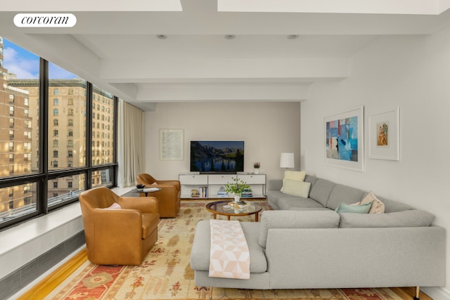 living room featuring beam ceiling and hardwood / wood-style floors