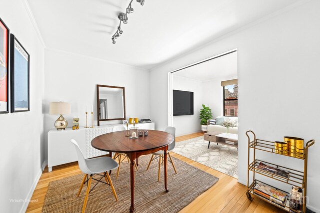 dining space with radiator, hardwood / wood-style floors, and sink