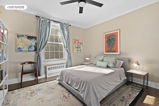 bedroom featuring ceiling fan, dark hardwood / wood-style flooring, ornamental molding, and radiator heating unit