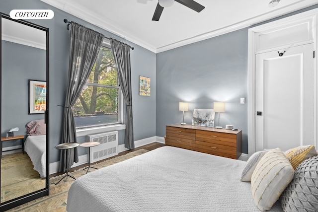 bedroom with ceiling fan, radiator, and ornamental molding