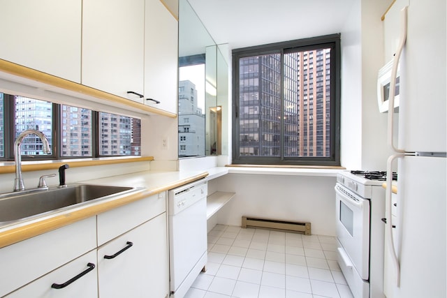 kitchen featuring white appliances, baseboard heating, light countertops, white cabinetry, and a sink