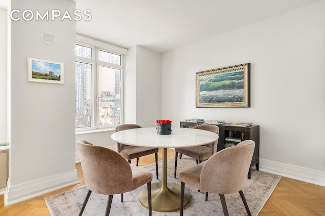 dining room featuring plenty of natural light and light parquet floors