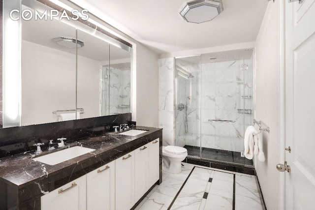 bathroom featuring vanity, toilet, and a shower with shower door