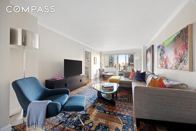 living room featuring wood-type flooring and crown molding