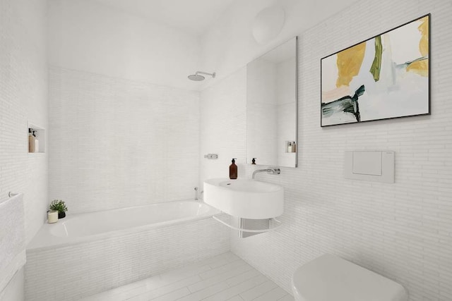 bathroom featuring tile walls, tile patterned floors, and toilet