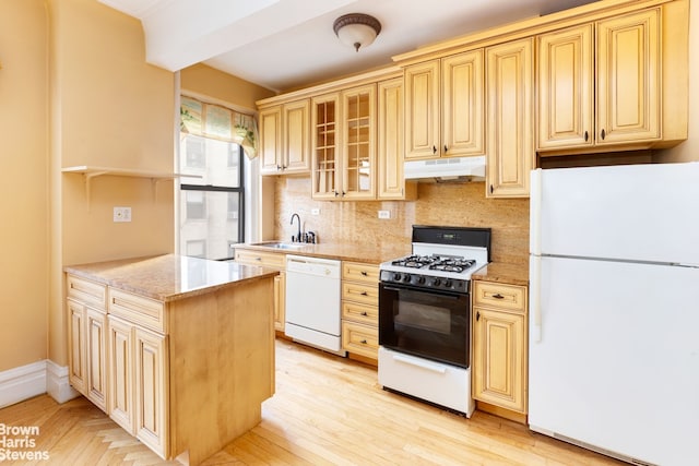 kitchen featuring sink, light brown cabinets, white appliances, light stone countertops, and decorative backsplash